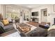 The expansive living room includes a comfortable sofa, large windows, a patio slider, and a media center at 3418 New Haven Cir, Castle Rock, CO 80109