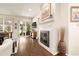 A living room features a modern fireplace, large windows, a patio slider, and hardwood floors at 3418 New Haven Cir, Castle Rock, CO 80109