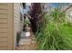 Charming side yard with lush greenery, rock pathway, and a well-maintained home exterior at 3418 New Haven Cir, Castle Rock, CO 80109
