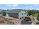 Aerial of a large backyard with a shed, patio, wooden fence, and desert landscaping at 42013 Big Horn Cir, Elizabeth, CO 80107