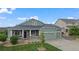 Charming single-Gathering home featuring a well-manicured lawn and a welcoming front porch at 42013 Big Horn Cir, Elizabeth, CO 80107