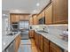 Bright kitchen features stainless appliances, countertops, and warm wood cabinets at 42013 Big Horn Cir, Elizabeth, CO 80107