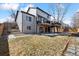 Exterior view of a two-story home showcasing a well-maintained backyard and tiered deck at 8983 W Capri Ave, Littleton, CO 80123