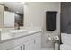 Modern bathroom featuring a square vessel sink on a white countertop and gray tiled shower at 8983 W Capri Ave, Littleton, CO 80123