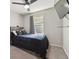 Cozy bedroom featuring a comfy bed, soft carpet, and natural light from the window at 8983 W Capri Ave, Littleton, CO 80123