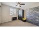 Neutral bedroom featuring a large window, wardrobe, and ample storage enhancing a clutter-free space at 8983 W Capri Ave, Littleton, CO 80123