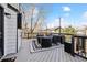 Outdoor deck area with stylish furniture, outdoor TV, and a cozy rug for relaxing and entertaining at 8983 W Capri Ave, Littleton, CO 80123