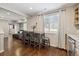 Open dining area featuring a wooden table, hardwood floors, and natural light from the window at 8983 W Capri Ave, Littleton, CO 80123