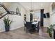 Spacious dining area with a modern light fixture, sleek furniture, and a staircase at 8983 W Capri Ave, Littleton, CO 80123