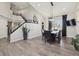 Dining area with high ceilings, a modern chandelier, and staircase at 8983 W Capri Ave, Littleton, CO 80123