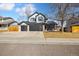 Charming two-story home featuring a three-car garage and a covered front porch at 8983 W Capri Ave, Littleton, CO 80123