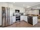 Modern kitchen showcases stainless steel appliances, including a refrigerator, oven, and dishwasher at 8983 W Capri Ave, Littleton, CO 80123