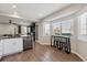 Eat-in kitchen area with natural light, features a breakfast bar and sleek countertops at 8983 W Capri Ave, Littleton, CO 80123