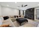 Comfortable living room with a modern fireplace, large TV, and natural light streaming through the windows at 8983 W Capri Ave, Littleton, CO 80123