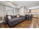 Cozy living room with hardwood floors, a comfortable sectional sofa, and natural light at 8983 W Capri Ave, Littleton, CO 80123