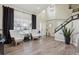 Bright living room with high ceilings, modern furniture, and a staircase at 8983 W Capri Ave, Littleton, CO 80123