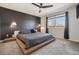 Stylish main bedroom with a platform bed, accent wall, and ample natural light from the window at 8983 W Capri Ave, Littleton, CO 80123