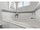 Bright bathroom with a large tub, mosaic tile accent, and white fixtures at 4548 E Kentucky Cir, Denver, CO 80246