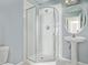Bathroom with white pedestal sink and glass-enclosed shower with chrome fixtures at 4548 E Kentucky Cir, Denver, CO 80246