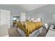 Charming bedroom with light blue walls, white iron bed frame, and a large mirror at 4548 E Kentucky Cir, Denver, CO 80246