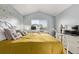 Bright bedroom showcasing a bed, desk area by the window, and a dresser with a TV at 4548 E Kentucky Cir, Denver, CO 80246