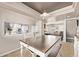 Bright dining area with a view into the modern kitchen, creating an open and inviting atmosphere at 4548 E Kentucky Cir, Denver, CO 80246