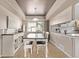 Elegant dining room with a tray ceiling, pendant lighting, and stylish buffet, perfect for Gathering meals at 4548 E Kentucky Cir, Denver, CO 80246