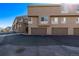 Exterior of modern townhomes showing attached garages and well-maintained landscaping at 4548 E Kentucky Cir, Denver, CO 80246
