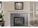 Elegant fireplace with a decorative mantle, framed artwork, and a cozy ambiance at 4548 E Kentucky Cir, Denver, CO 80246