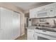 Kitchen with white cabinets, granite counters, stainless steel appliances, and a large pantry at 4548 E Kentucky Cir, Denver, CO 80246