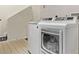 Convenient laundry room featuring a front-load washer and dryer at 4548 E Kentucky Cir, Denver, CO 80246