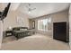 Spacious main bedroom with a ceiling fan, large window, and a dark wardrobe at 4548 E Kentucky Cir, Denver, CO 80246