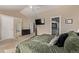 Main bedroom featuring a television on the wall, ensuite bathroom, and a large walk-in closet at 4548 E Kentucky Cir, Denver, CO 80246