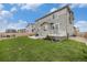 Spacious backyard with a well-maintained lawn and a charming patio, perfect for outdoor gatherings at 12405 E 101St Dr, Commerce City, CO 80022
