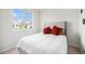 Minimalist bedroom with a queen bed, bright natural light, and a view of the neighborhood at 12405 E 101St Dr, Commerce City, CO 80022