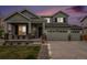 Two-story home boasts a three-car garage, a covered porch, and well-maintained landscaping at 12405 E 101St Dr, Commerce City, CO 80022