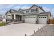 Beautiful two-story home with a large driveway, spacious three car garage and manicured front yard at 12405 E 101St Dr, Commerce City, CO 80022