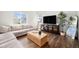 Bright living room with comfortable seating, large windows, and stylish décor at 12405 E 101St Dr, Commerce City, CO 80022