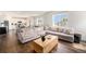 Bright, open living room with hardwood floors and a view of the kitchen at 12405 E 101St Dr, Commerce City, CO 80022