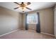 Simple bedroom with neutral walls and a ceiling fan at 11690 Stoneybrooke St, Parker, CO 80138