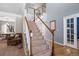 Elegant staircase with wooden railings and carpeted steps at 11690 Stoneybrooke St, Parker, CO 80138