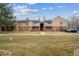 Exterior of a two-story townhome featuring a well-maintained lawn and balcony at 3320 S Ammons St # 104, Lakewood, CO 80227