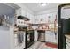 Bright kitchen with stainless appliances, black countertops, and white cabinets at 3320 S Ammons St # 104, Lakewood, CO 80227