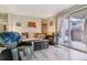 The living room has wood floors and an access door to the balcony at 3320 S Ammons St # 104, Lakewood, CO 80227