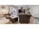 Bright living room with hardwood floors, sliding glass doors, and decorative plant at 3320 S Ammons St # 104, Lakewood, CO 80227