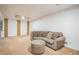 Cozy finished basement featuring carpeting, neutral colors, and comfortable seating at 1063 W Powers Ave, Littleton, CO 80120