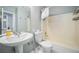 Cozy bathroom features updated fixtures including a pedestal sink and toilet at 1063 W Powers Ave, Littleton, CO 80120