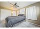 Comfortable bedroom featuring a ceiling fan and natural light from the windows at 1063 W Powers Ave, Littleton, CO 80120