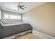 Bedroom with ceiling fan and large window; wood frame bed at 1063 W Powers Ave, Littleton, CO 80120