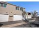 Exterior view of townhomes featuring multiple garages and well-kept surroundings at 1063 W Powers Ave, Littleton, CO 80120